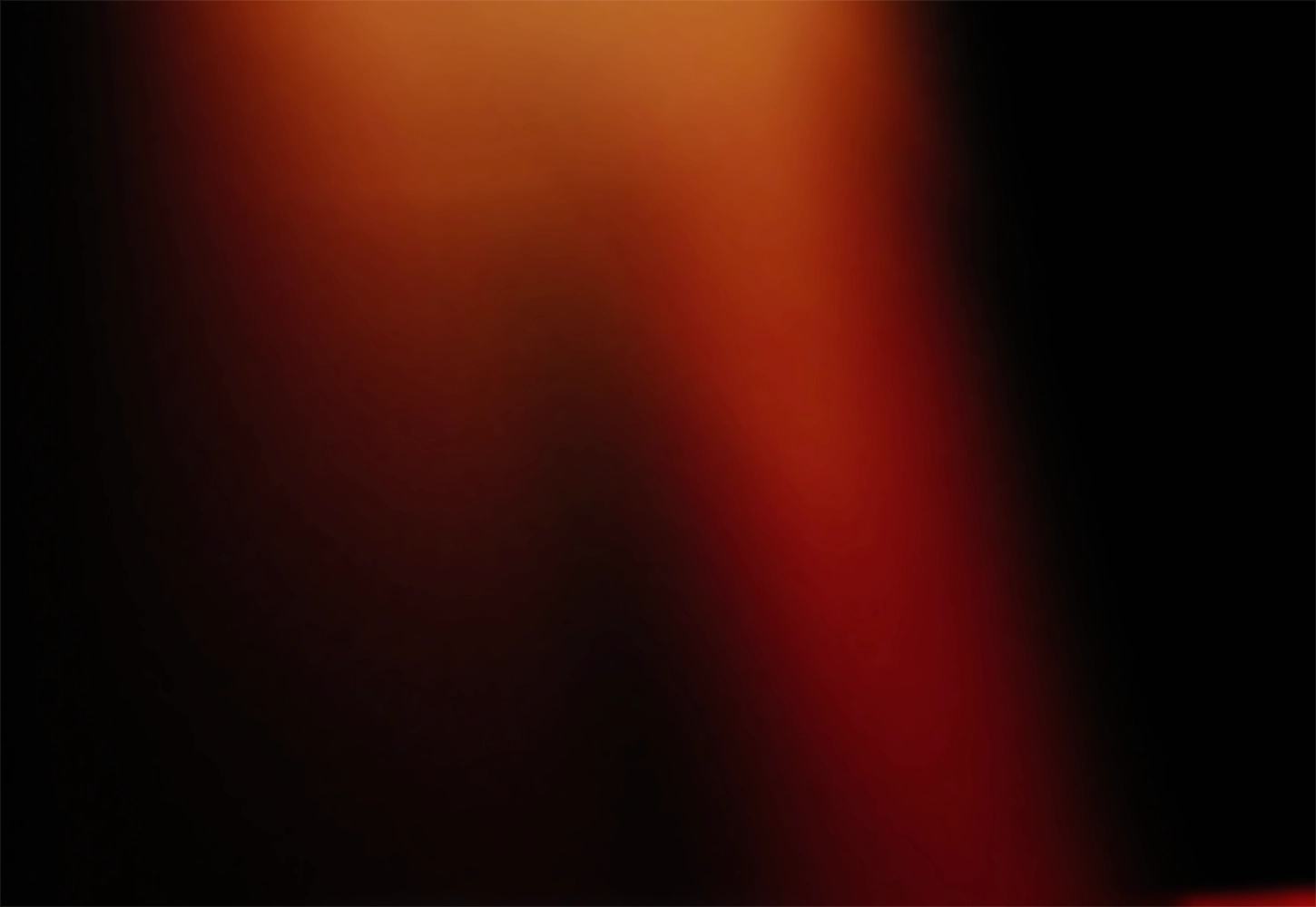 A beam of red and orange light illuminates darkness.